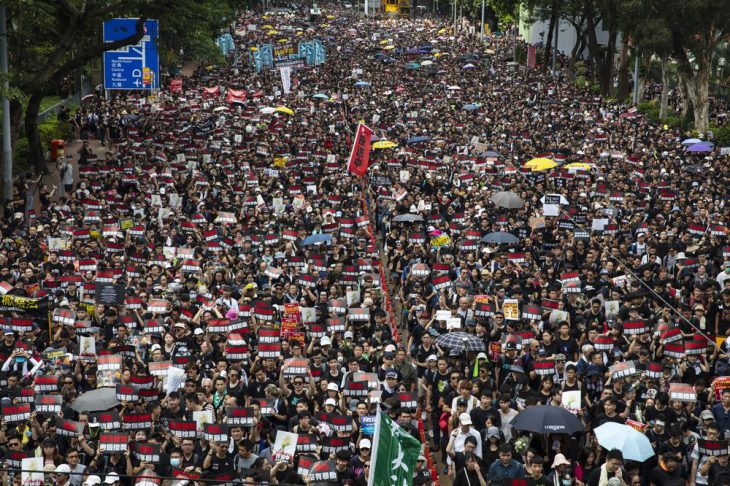 Tens of thousands of anti-government demonstrators march to give Chinese visitors the reasons for their mass protests.