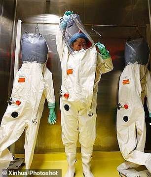Mysterious Wuhan virus lab: Rare pictures show scientists dressed like astronauts studying deadly pathogens in controversial institute